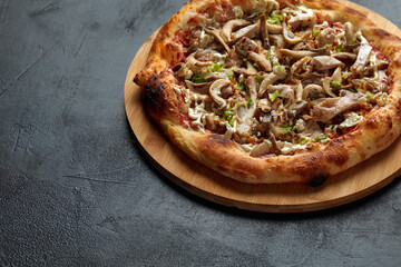 Appetizing pizza with mushrooms on a wooden tray