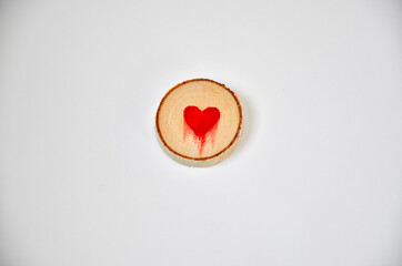 Pine tree slice with red blood heart symbol on white background. Valentines day wallpaper