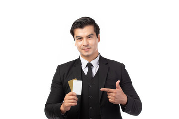 Handsome business man in black suit holding and finger pointing to credit card isolated on white background. Business, technology, ecommerce and online payment concept.