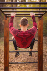 Fototapeta premium Man working out on monkey bars