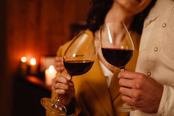 White romantic couple hugging while drinking wine at home