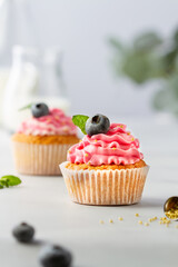 Cupcake with cream and blueberries