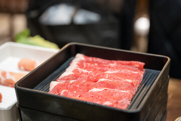 Sliced beef on a black tray, suki shabu, Japanese style food