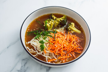 vegan ramen noodles soup with carrots and broccoli, healthy plant-based food