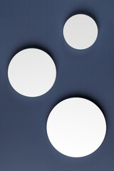 Podiums. White round podiums for presentation. Natural beauty pedestal on blue background. Photography. Top view. Two round podiums