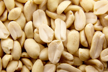 Raw blanched peanuts as food background