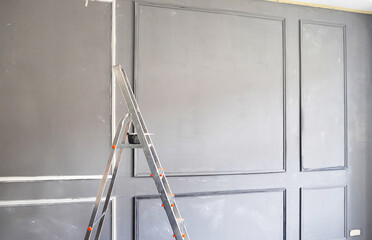 process of installation and painting of moldings for the interior in a classic minimalist style