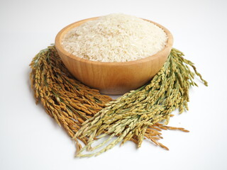 Jasmine rice in wooden bowl isolated on white background. closeup photo, blurred.