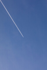 Plane flying in the skies of Austria with a completely blue sky.