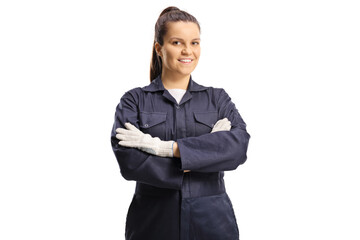 Young female worker in an overall uniform and gloves posing - obrazy, fototapety, plakaty