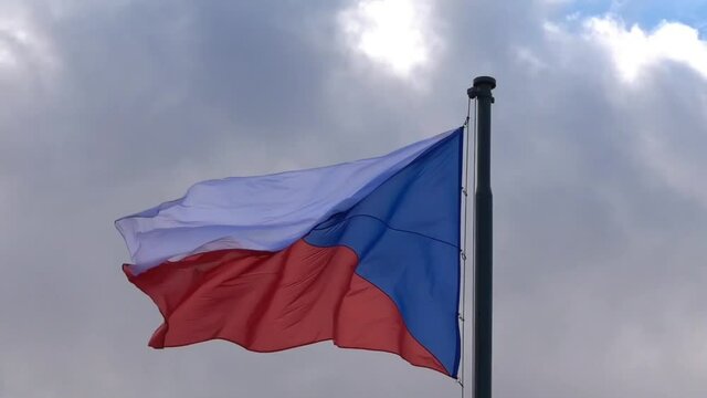 Video of waving Czech flag in Prague on Vitkov on a cloudy sky.