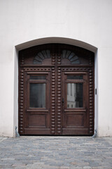 Fototapeta na wymiar old big and wide wooden door in a stone wall