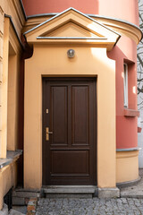 Old, brown wooden door on the  house with bright colors, in the city center of Warsaw