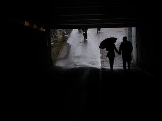 silhouettes people pedestrian underpass