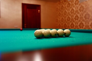 Billiard balls on a green table cloth.