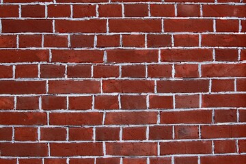 Red brick wall with white painted seams.