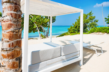 white bed on the sandy beach of the sea