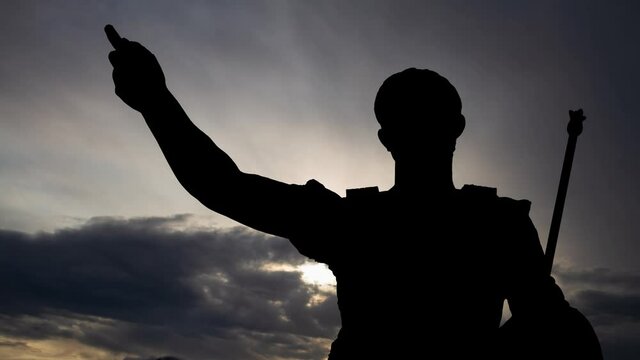 Gaius Julius Caesar: Time Lapse at Sunrise with Fast Clouds and Dark Silhouette of Roman Emperor