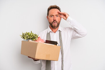 middle age man looking happy, astonished and surprised. unemployment concept
