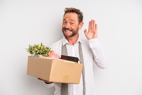 middle age man smiling happily, waving hand, welcoming and greeting you. unemployment concept