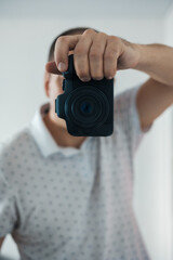male photographer taking photo with dslr camera