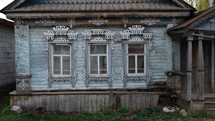 Fototapeta na wymiar wooden country house with carved patterns on the windows
