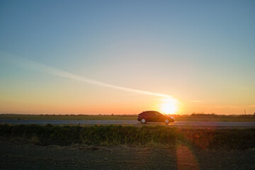 Aerial view of intercity road with blurred fast driving car at sunset. Top view from drone of highway traffic in evening