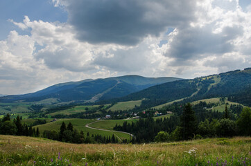 Fototapeta premium Mountain landscape. countryside landscape. beautiful views of the mountains in the summer. green trees and beautiful cloudy sky.