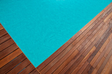 Ipe wood right up to the pool edge, natural structure of hardwood contrasting with blue swimming pool water