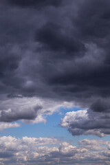 Epic dramatic Storm sky, dark grey and white cumulus clouds on blue sky background texture, thunderstorm