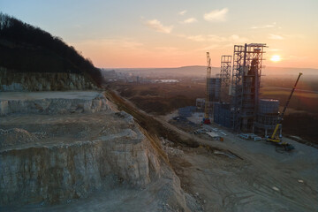 Cement factory at open pit mining of construction sand stone materials. Digging of gravel resources...