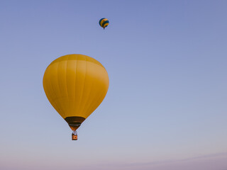 view of air balloon with basket flies on sunset