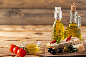 Italian ciabatta bread with olive oil on wooden background