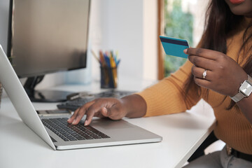 Fototapeta premium Unrecognizable woman shopping online and paying with a credit card.