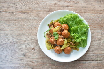 deep fried fish tofu ball with chop pork topping slice sweet green chili in sauce on plate