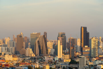 Fototapeta premium Aerial view of Bangkok Downtown Skyline, Thailand. Financial district and business centers in smart urban city in Asia. Skyscraper and high-rise buildings at sunset.