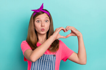 Photo of funky cute preteen kid make hands heart figure send air kiss wear stylish t-shirt isolated on turquoise color background