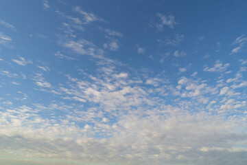 Clear blue sky with white fluffy clouds at noon. Day time. Abstract nature landscape background.