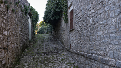 Alley in Erice, Sicily, Italy. Paved street and houses.