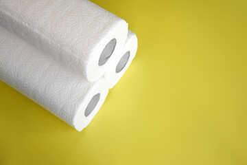 Absorbent paper napkin kitchen towels on yellow background.