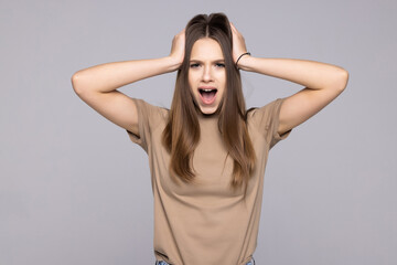Fototapeta premium Surprised happy woman looking sideways in excitement on gray background