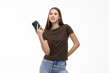 Fototapeta premium Portrait of smiling young pretty woman use smartphone isolated on white background
