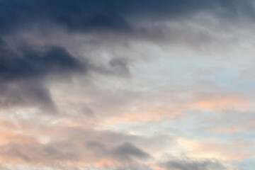 dramatic cirrus, feathery clouds against bright blue cloudy sky in the evening	