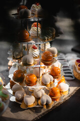 Dessert table for a party. Ombre cake, cupcakes, sweetness and other sweets. Vertical view for social media