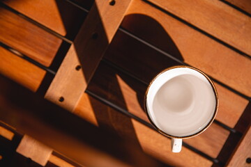 Empty cup, top view on beautiful wooden background. Great picture for baner or menu