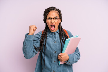 black afro woman shouting aggressively with an angry expression. university student concept