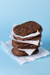 Stack of Delicious Chocolate Cookies with Oatmeal on Blue Background Copy Space Tasty Homemade Cookies