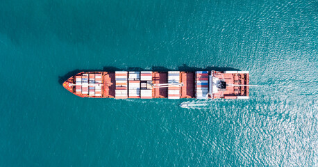 Aerial tip view of cargo ship carrying container and running for export  goods  from  cargo yard...
