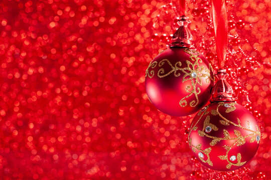 Red Background Template. Christmas Ball with copy space. Xmas Hanging Red balls red bokeh background.  