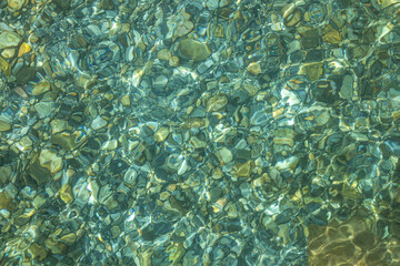 Naklejka na ściany i meble Beautiful blue and yellow texture of color smooth stones with water is in the lake